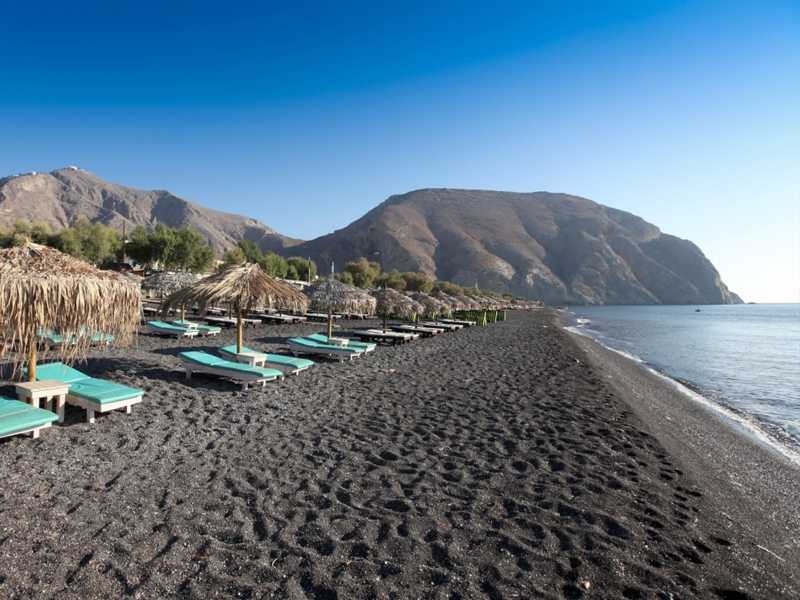 a huge beach with black pebbles and everything you need to be organized.